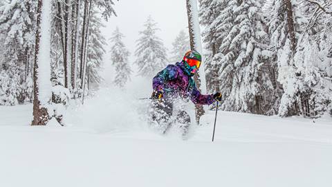 skier charging through powder